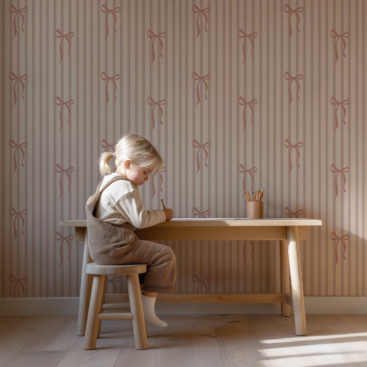 Kind aan een houten bureau voor Striped Bows dusty blush behang