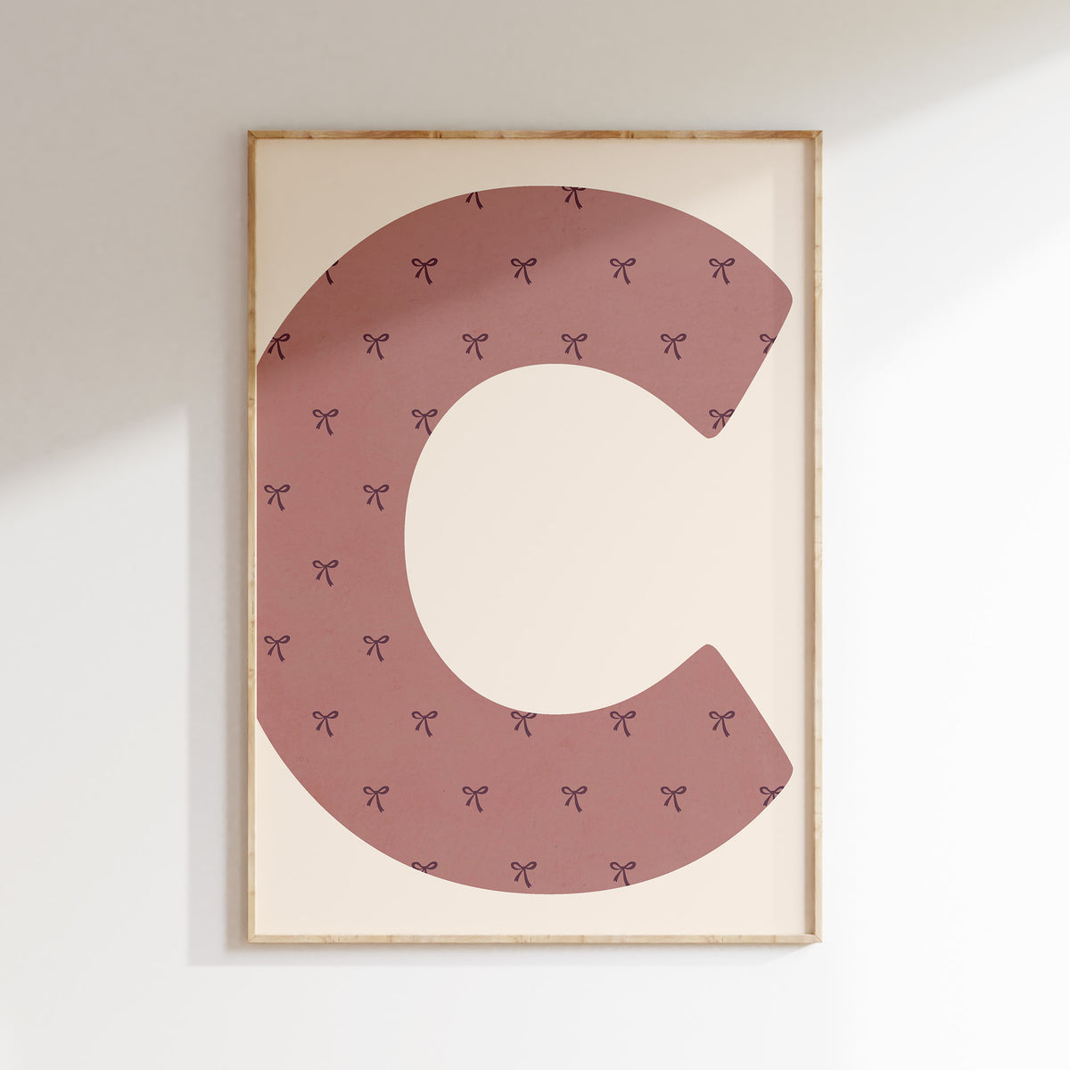 Gepersonaliseerde letterposter met strikjes in mauve in een meisjeskamer