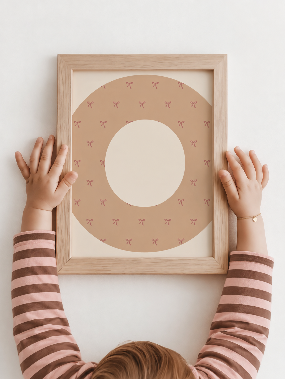 Zandkleurige letterposter met sierlijke strikjes in een warme kinderkamer